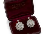 an image of a pair of diamond earrings in a velvet case