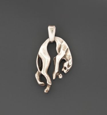 a silver pendant with two hands holding each other