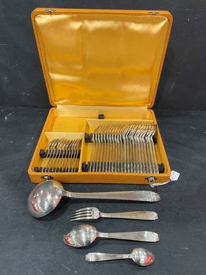 a yellow case with silverware in it on a table