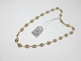 a close up of a gold chain with a price tag on it