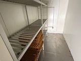 a long shelf with baskets on it in a room