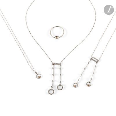 three silver necklaces and a ring on a white background