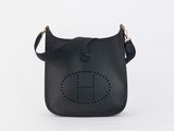 a black handbag with a monogram logo on the front