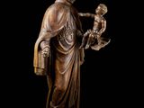 a bronze statue of a man holding a child