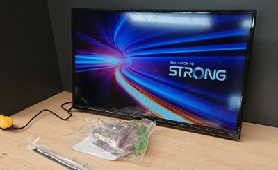 a tv that is sitting on a table with a remote