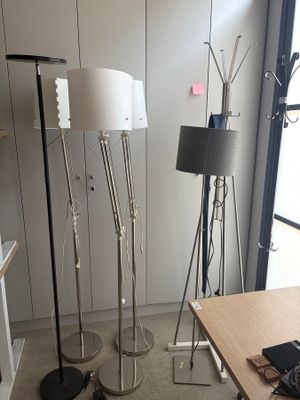 three lamps that are on a stand in a room