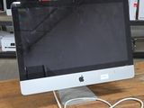 a computer monitor sitting on top of a wooden desk