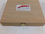 an empty wooden box with a sticker on the lid