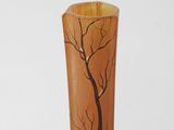 a vase that has a tree on it on a table
