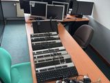 a desk with a bunch of computer monitors on it