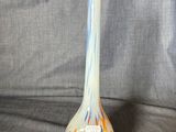 a glass vase that is sitting on a gray cloth