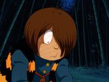 cartoon image of a boy with a cat tail sitting in front of a bamboo forest