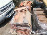 a pile of tile on the ground next to a van