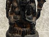 a statue of a man holding a bird on a table