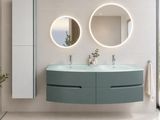 two round mirrors on the wall above a double sink