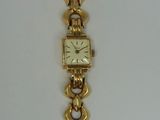 an image of a gold watch with a chain around it