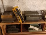 a shelf that has a bunch of old typewriters on top of it