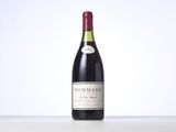 a bottle of red wine sitting on top of a table