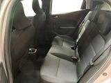 the back seats of a car with the door open and the driver ' s seat down