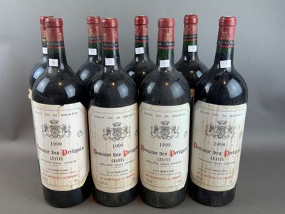 six bottles of red wine are lined up on a table