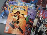a lot of comic books on the table together