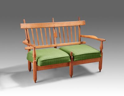 a wooden bench with two green cushions on it