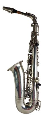 a silver saxophone that is sitting on a white surface