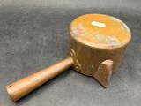 an old wooden mallet with a wooden handle sitting on a table