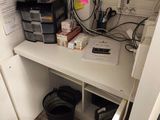 a white desk with a computer on it in a small room