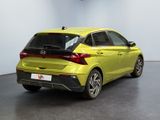 the rear end of a yellow car in a showroom