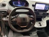 the interior of a car with a steering wheel, dashboard, and display screen