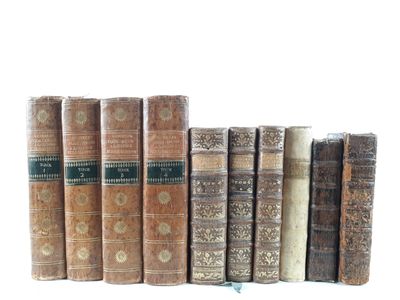 several old books are lined up in a row on a white surface
