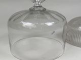 a glass jar with a lid on a white table