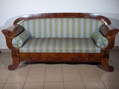 a couch that is sitting on a tiled floor