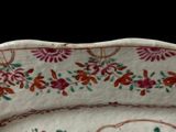 a plate with a floral design on it on a table