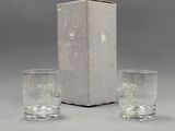 two glasses and a box on a table with a box in the background