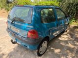 a small blue car parked on the side of the road