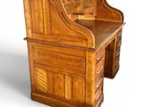 an image of a wooden desk with a drawer underneath it