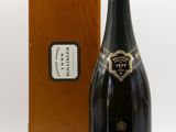 an image of a bottle of champagne in front of a wooden box