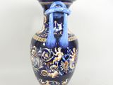 a blue vase with a blue handle on a white background