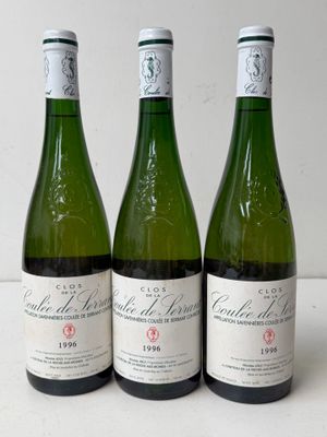three bottles of wine sitting on top of a table next to each other