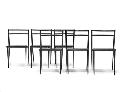 four black chairs sitting next to each other on a white surface