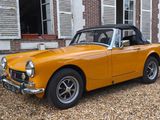 a yellow convertible car parked in front of a house