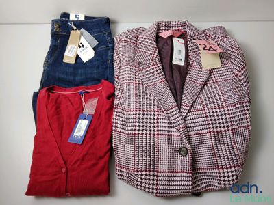 two jackets and a pair of jeans sitting on a table