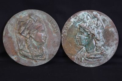 pair of ancient roman bronze coins depicting a woman and a man