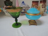 a green glass bowl and a blue glass bowl on a table