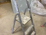 a ladder that is sitting in the middle of a room