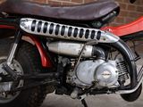 a close up of a motorcycle parked in front of a brick wall