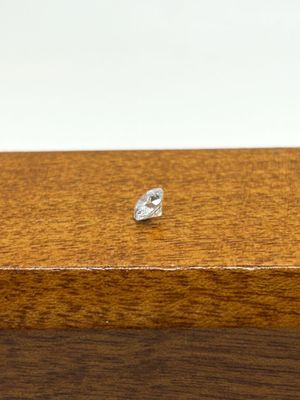 a small diamond sitting on top of a wooden box