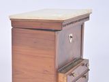 a small wooden table with a marble top on it